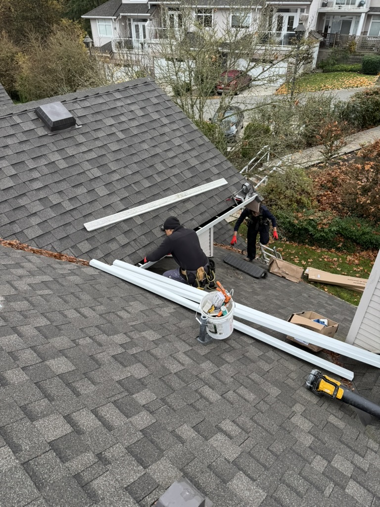 Westpoint Exteriors crew working safely along a residential gutter line