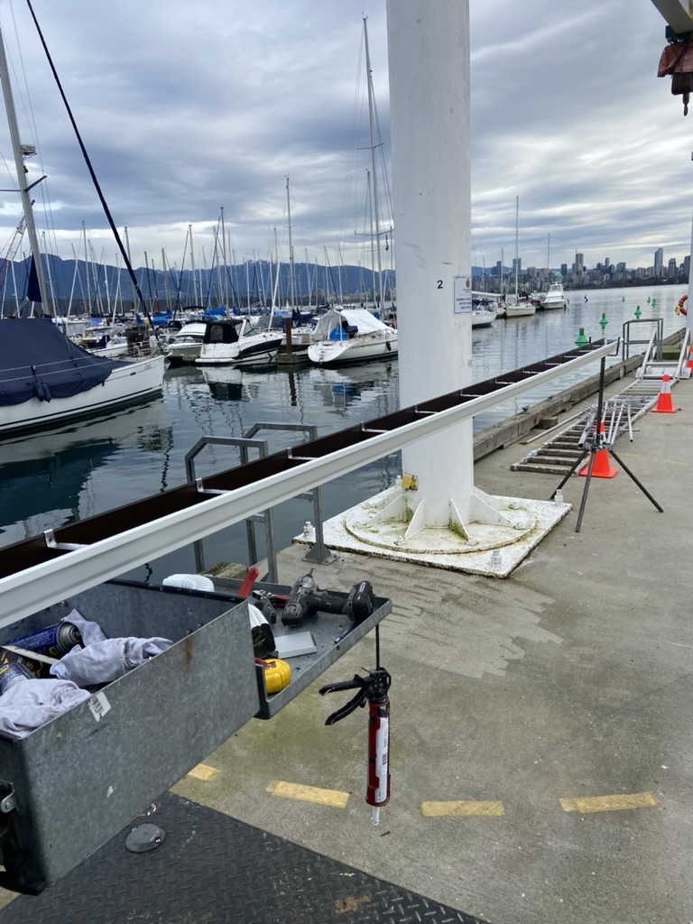 Gutter materials and tools staged for a waterfront property installation