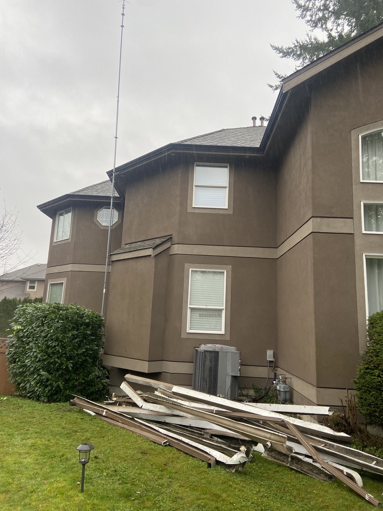 Removed gutter materials staged in a yard during replacement preparation