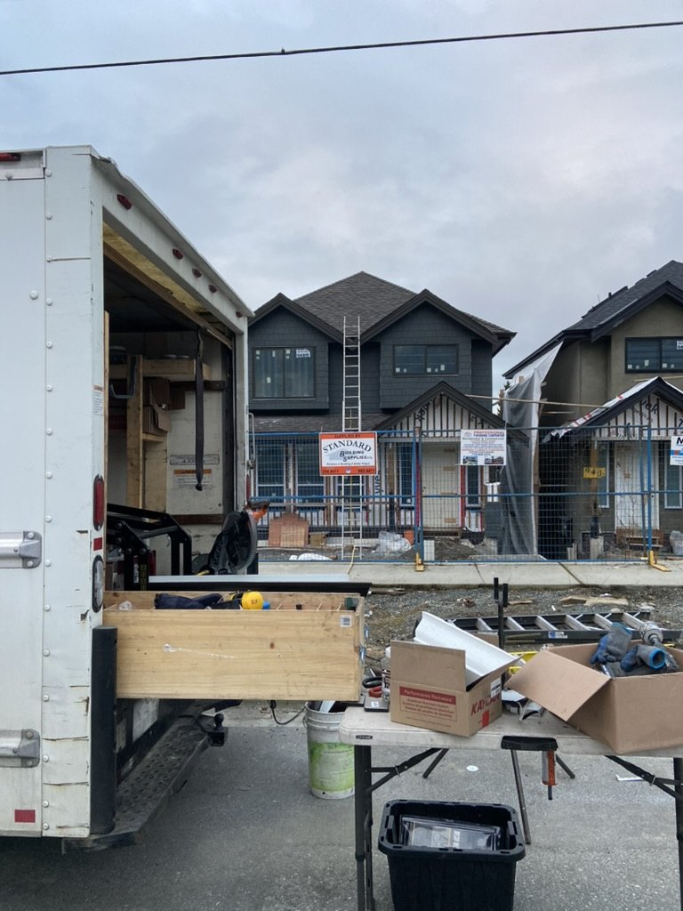 Mobile gutter fabrication setup at a residential job site
