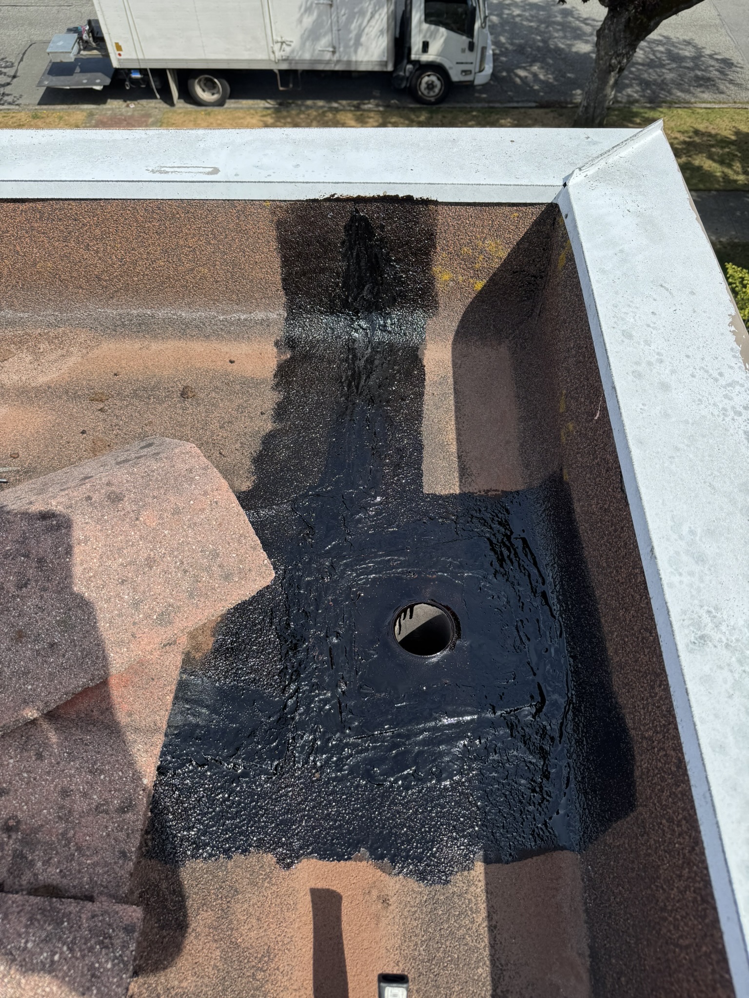 Black coating around repaired downspout outlet