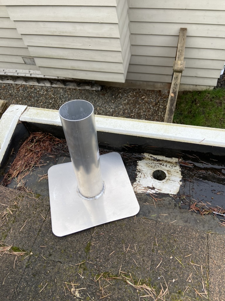 New metal outlet flange prepared for gutter repair
