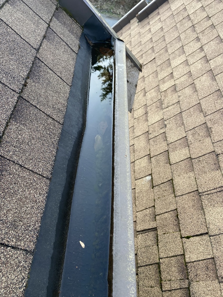 Standing water trapped inside a gutter channel