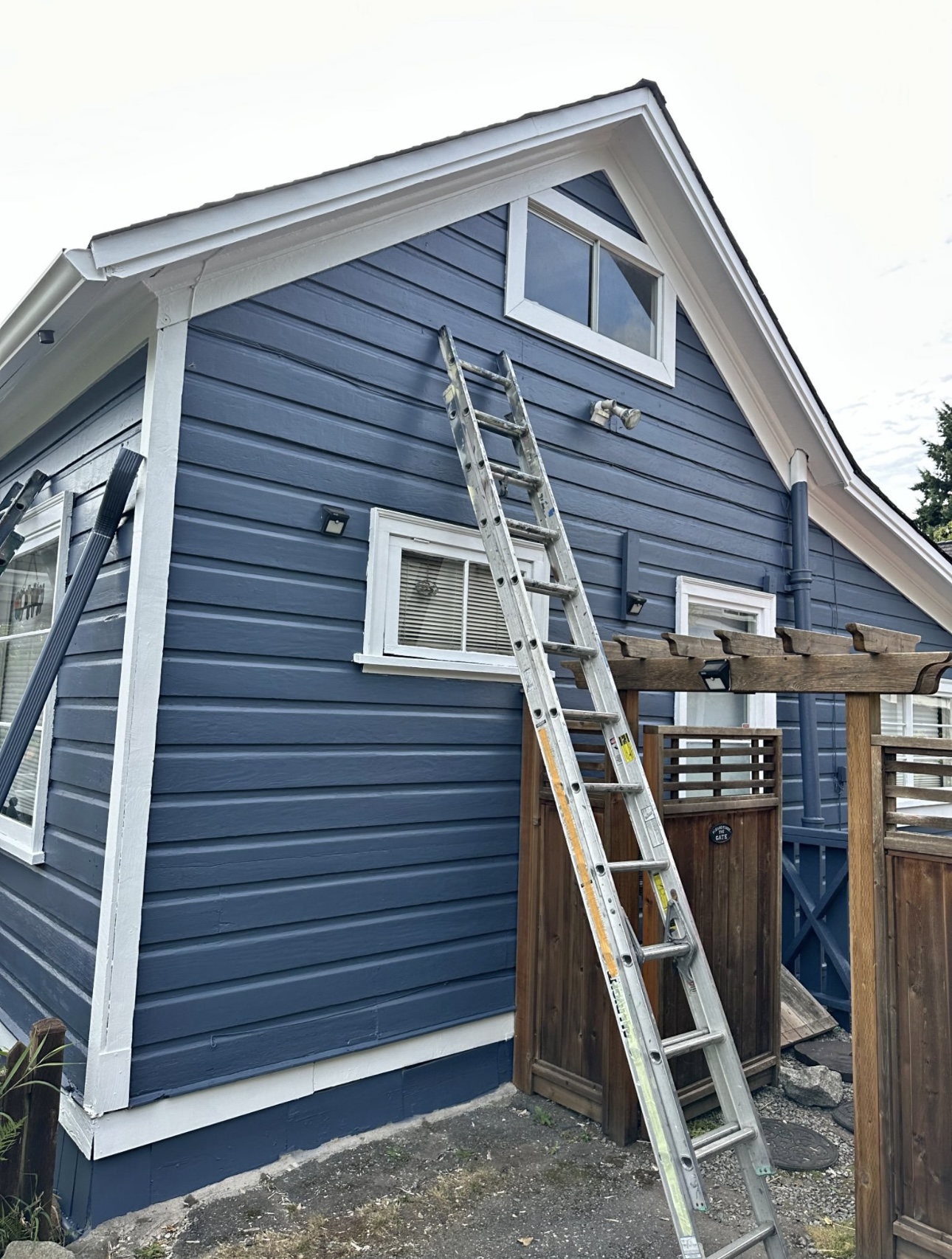 Finished blue exterior siding and white trim after painting
