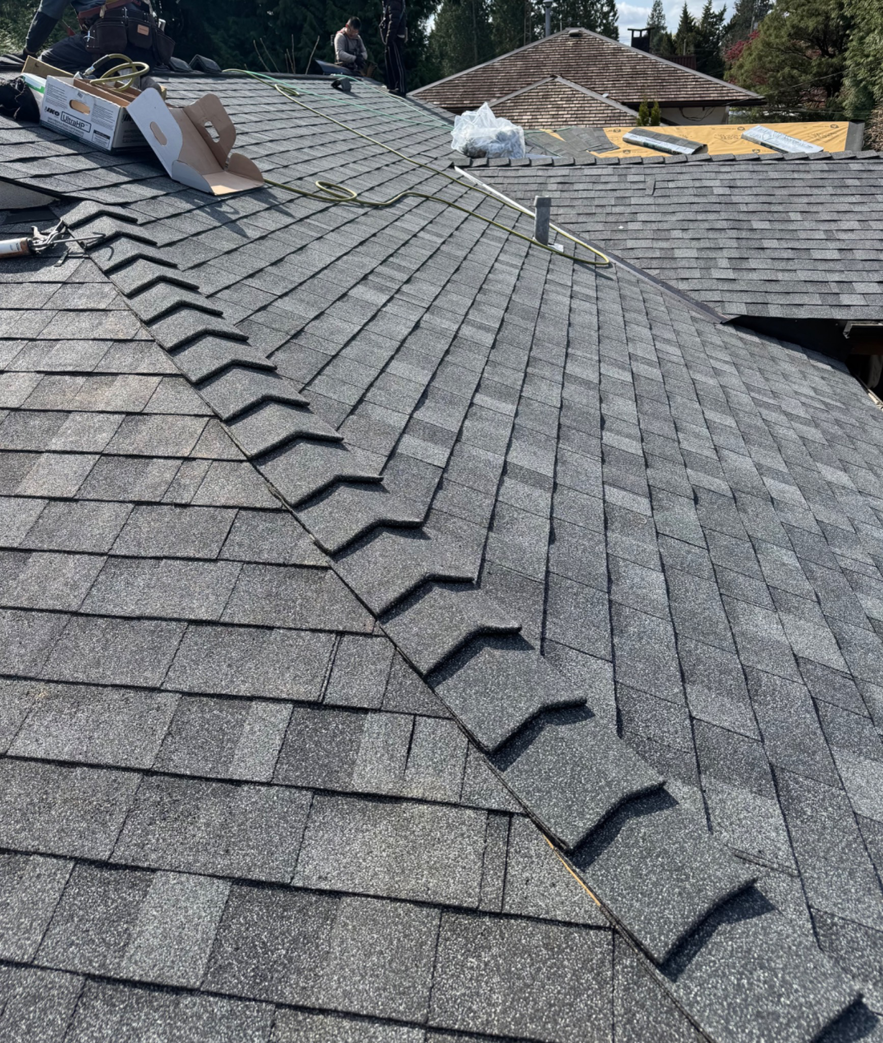 Finished ridge cap installation and shingle detail on a roof