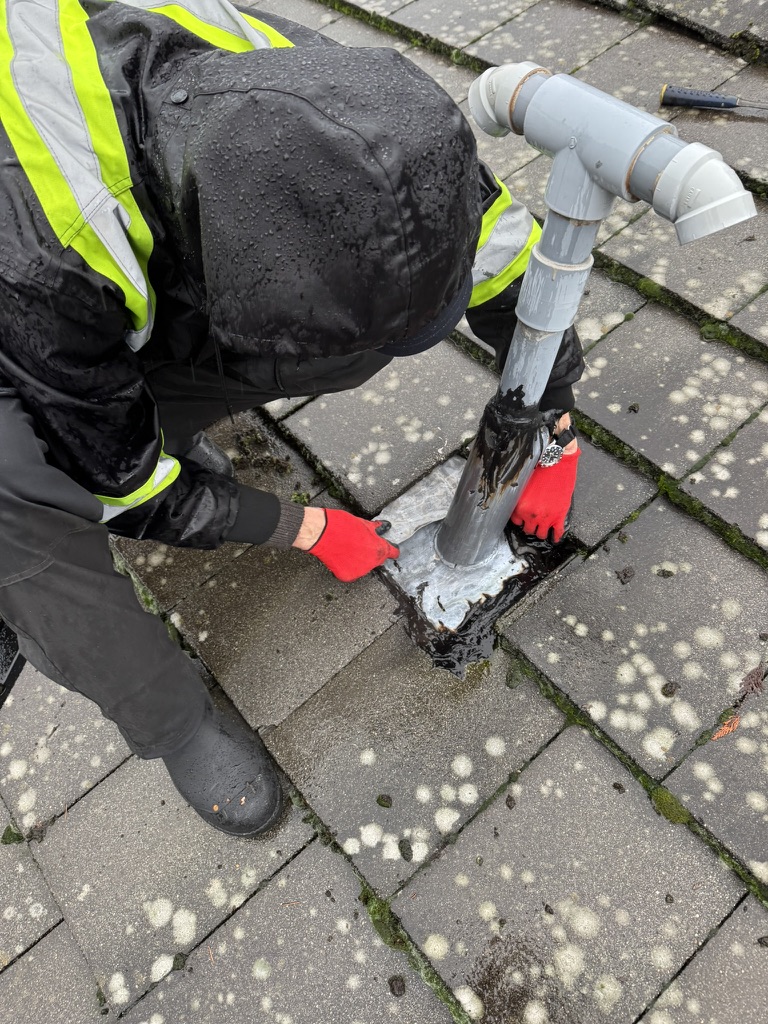 Worker repairing a roof penetration detail