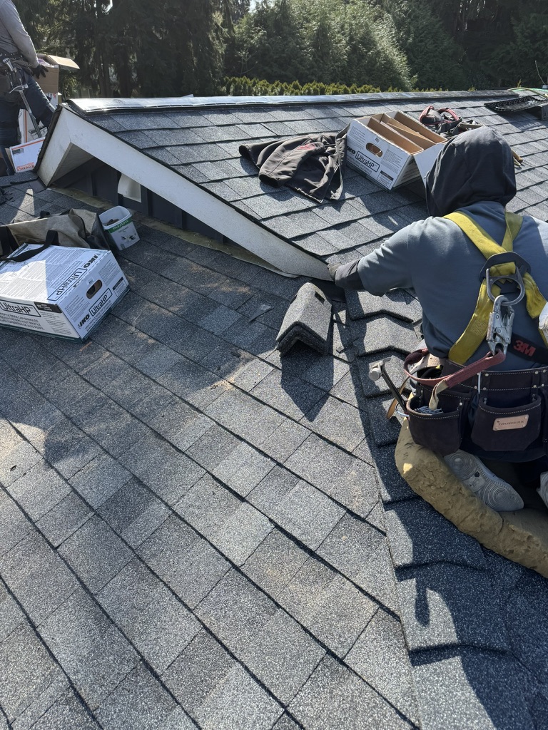 Roofing installation work on asphalt shingles