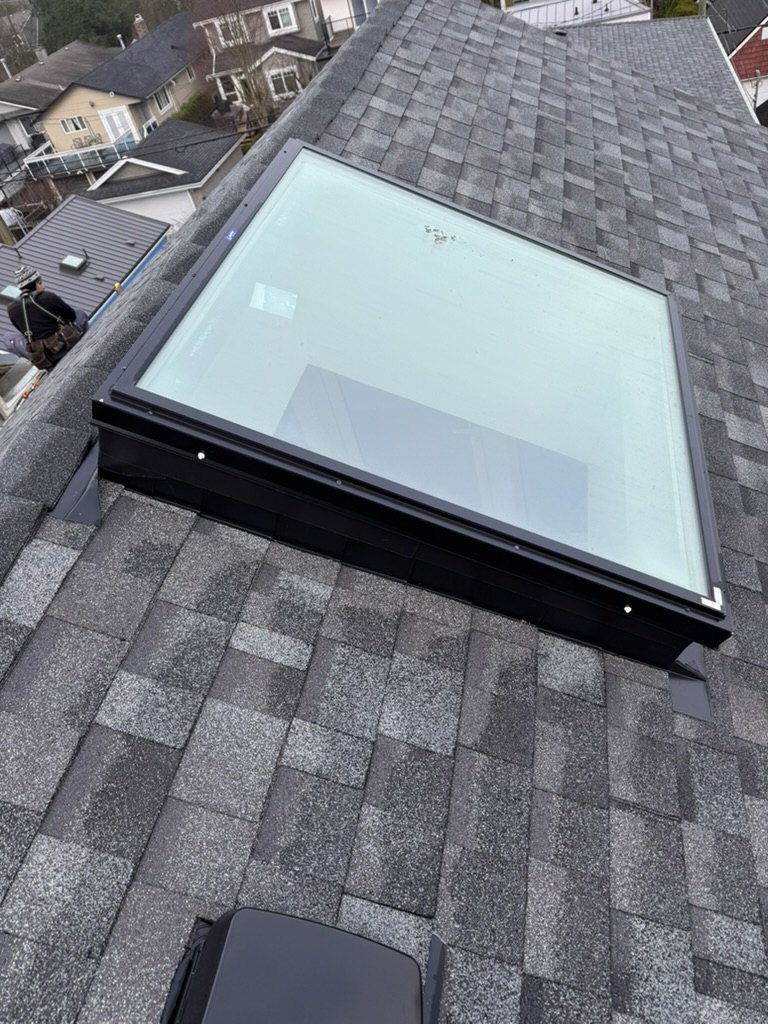 Finished asphalt shingle roof with skylight detail