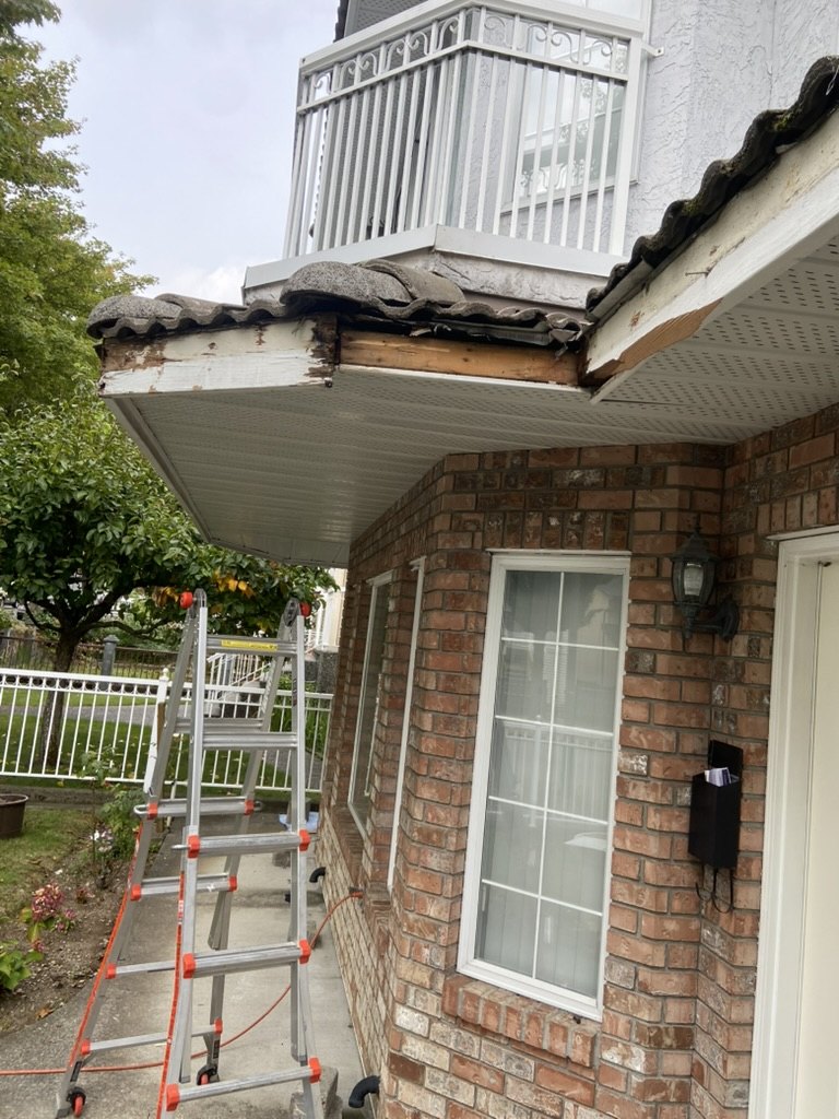 Damaged fascia on a brick home front roofline