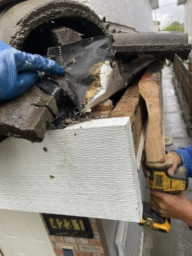 Rotted fascia and roof edge damage exposed for repair