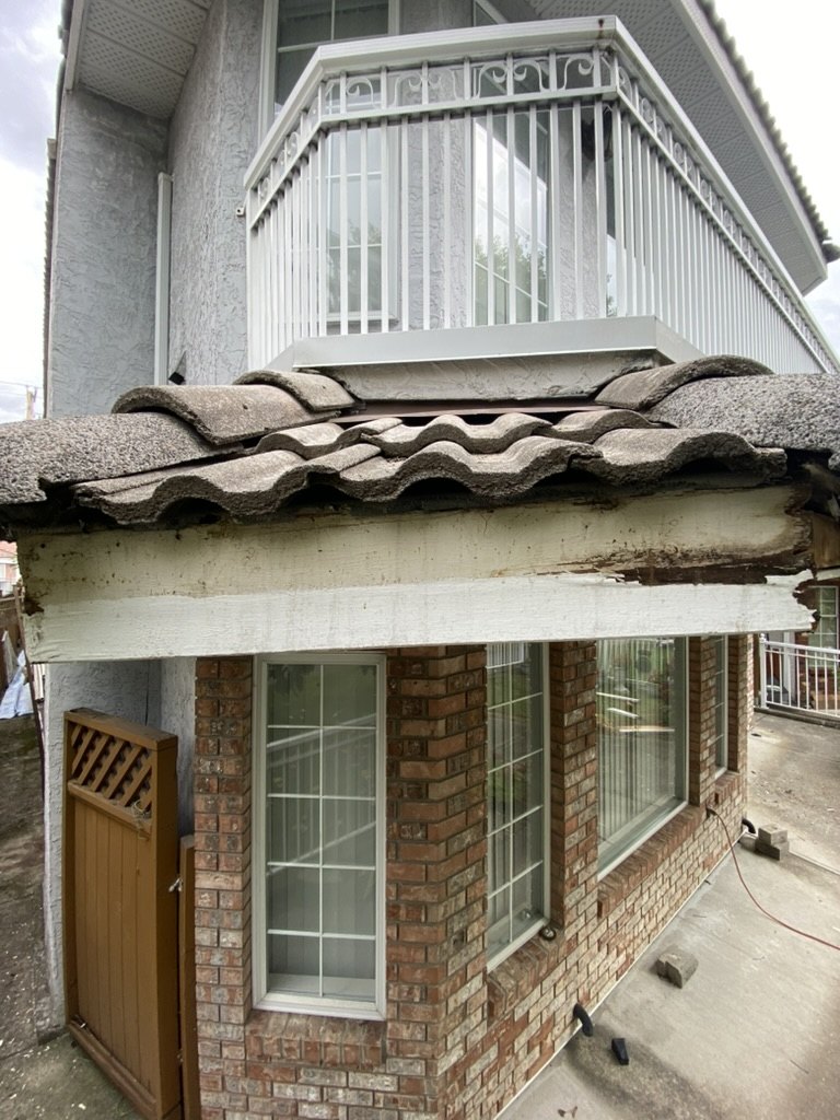 Close-up of damaged fascia and roof edge rot